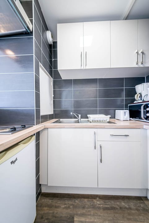 Family Apartment, 1 Bedroom | Private kitchen | Stovetop, coffee/tea maker, electric kettle, cookware/dishes/utensils