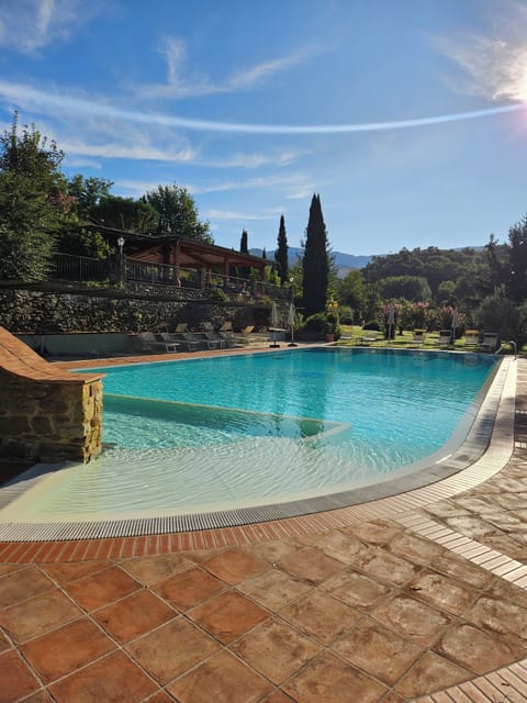 Outdoor pool, an infinity pool, pool umbrellas, sun loungers