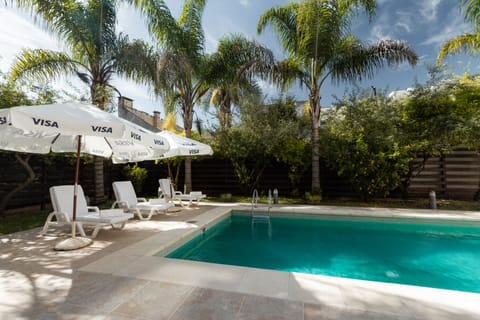 Seasonal outdoor pool, open 7 AM to 10 PM, pool umbrellas