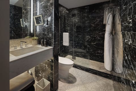 Designer toiletries, hair dryer, slippers, towels