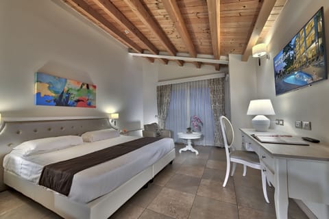 Deluxe Room, Lake View | Minibar, in-room safe, desk, laptop workspace