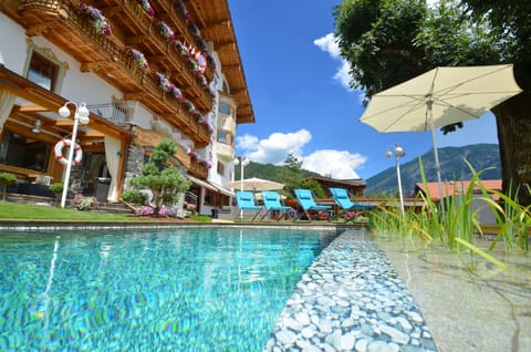 Outdoor pool, a natural pool, open 7:30 AM to 10 PM, pool umbrellas