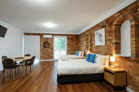 Standard Apartment | Desk, laptop workspace, blackout drapes, iron/ironing board