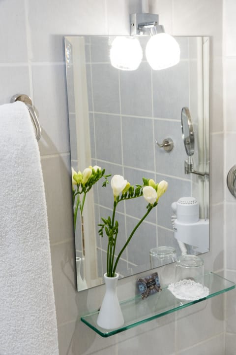 Shower, designer toiletries, hair dryer, slippers