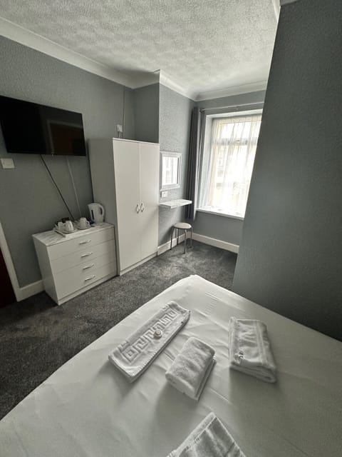 Desk, iron/ironing board, bed sheets