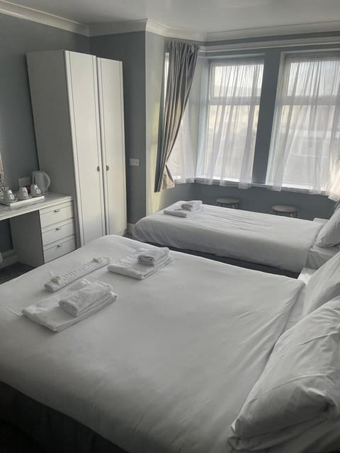 Family Room | Desk, iron/ironing board, bed sheets