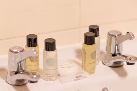 Combined shower/tub, designer toiletries, hair dryer, towels