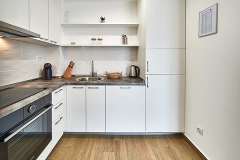 Fridge, stovetop, dishwasher, coffee/tea maker