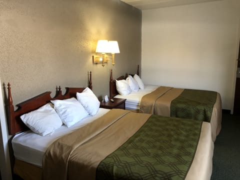 Desk, laptop workspace, bed sheets