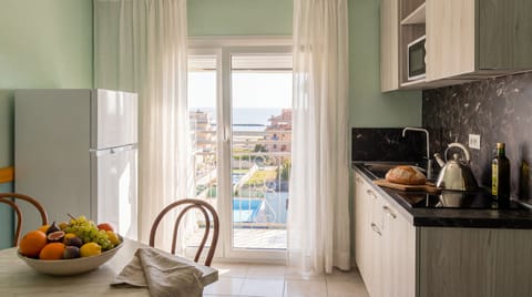 Full-size fridge, microwave, stovetop, coffee grinder