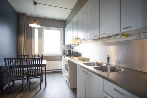 Deluxe Family Suite with Kitchen, Sauna & Balcony | Private kitchen | Full-size fridge, microwave, oven, stovetop