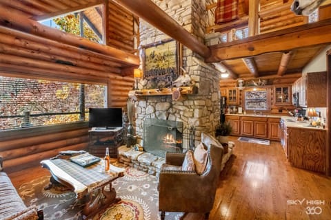 Luxury Cabin, Multiple Beds, Jetted Tub, Lake View (The Cattleman) | Living area | 50-inch Smart TV with satellite channels, fireplace, DVD player