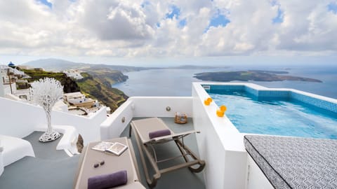 An infinity pool, a rooftop pool, pool umbrellas, sun loungers