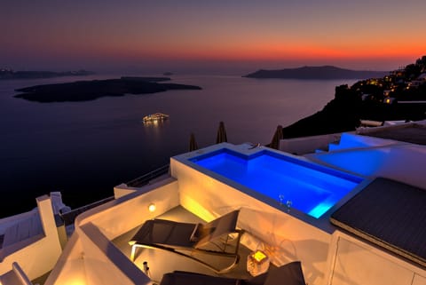 An infinity pool, a rooftop pool, pool umbrellas, sun loungers