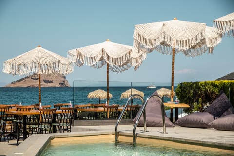 Seasonal outdoor pool, open 9:30 AM to 11:30 PM, pool umbrellas