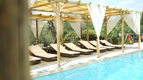 Seasonal outdoor pool, open 11:00 AM to 7:00 PM, pool umbrellas