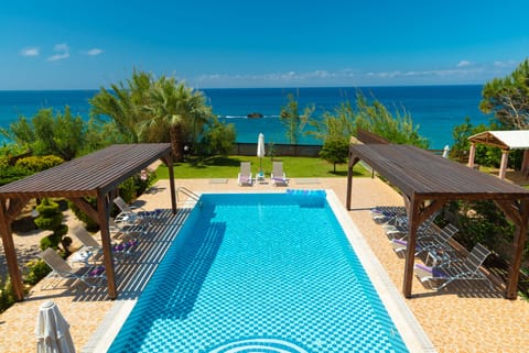 Outdoor pool, an infinity pool, pool umbrellas, sun loungers
