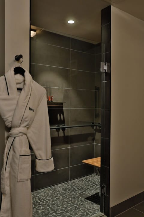 Shower, designer toiletries, hair dryer, towels