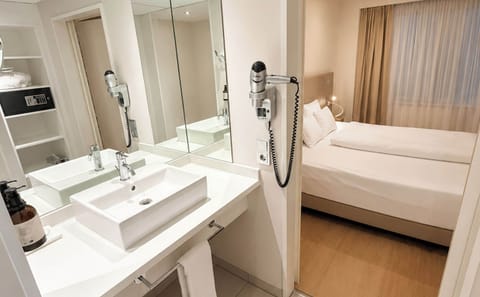 Deep soaking tub, rainfall showerhead, eco-friendly toiletries