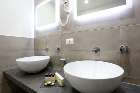 Deluxe Triple Room, 1 Bedroom, Refrigerator | Bathroom | Combined shower/tub, free toiletries, hair dryer, towels