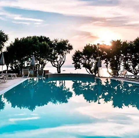 Outdoor pool, open 8:00 AM to 8:00 PM, pool umbrellas, sun loungers