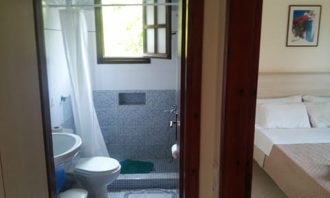 Shower, hair dryer, slippers, towels