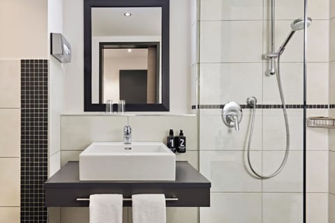 Shower, hair dryer, slippers, towels