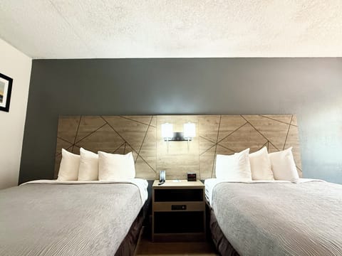 Premium bedding, desk, laptop workspace, blackout drapes