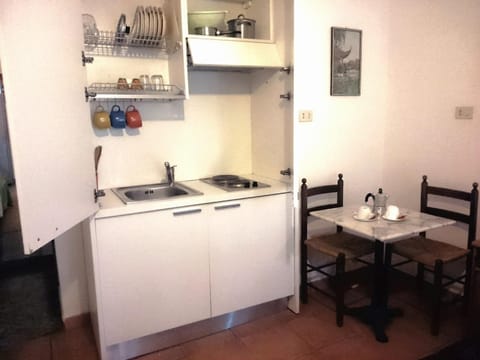 Full-size fridge, stovetop, cookware/dishes/utensils, cleaning supplies