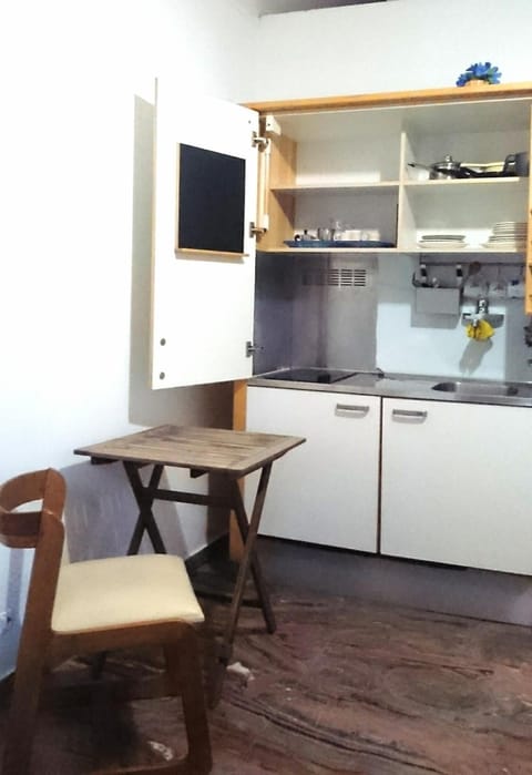 Full-size fridge, stovetop, cookware/dishes/utensils, cleaning supplies