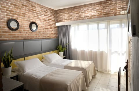 Double or Twin Room | Minibar, in-room safe, desk, blackout drapes