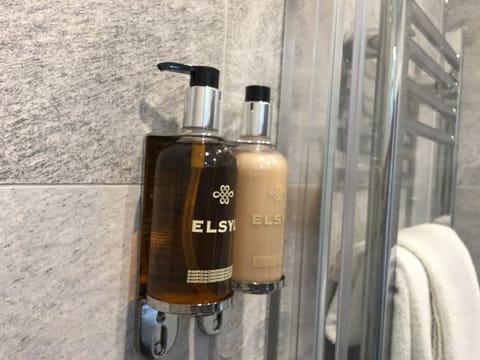 Shower, designer toiletries, hair dryer, towels