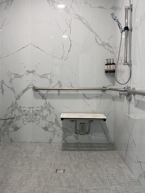 Shower, designer toiletries, hair dryer, towels