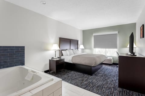 Suite, Non Smoking, Jetted Tub (1 King Bedroom) | Desk, iron/ironing board, free cribs/infant beds, rollaway beds