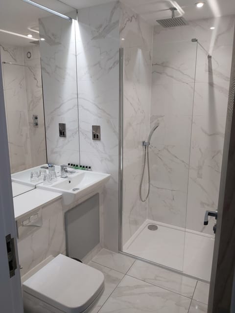 Shower, designer toiletries, hair dryer, towels