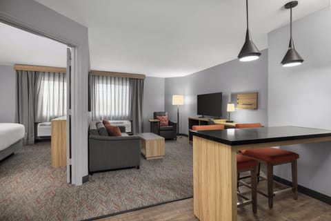 Suite, 1 Bedroom | Desk, blackout drapes, iron/ironing board, free WiFi