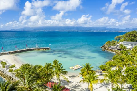 On the beach, white sand, sun loungers, beach umbrellas