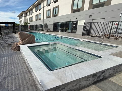 Seasonal outdoor pool, open 9:30 AM to 10:00 PM, pool umbrellas