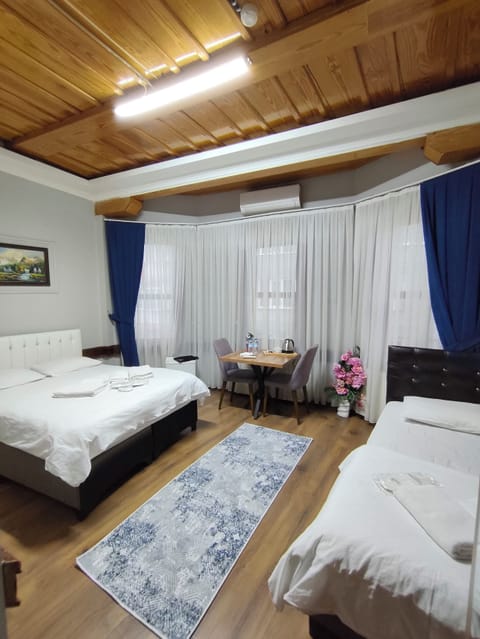 Standard Triple Room | Desk, blackout drapes, soundproofing, iron/ironing board