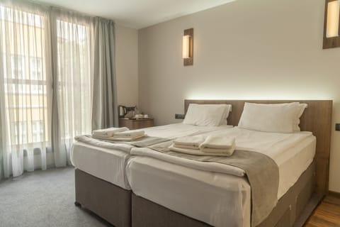 Double or Twin Room | Minibar, iron/ironing board, free cribs/infant beds, free WiFi