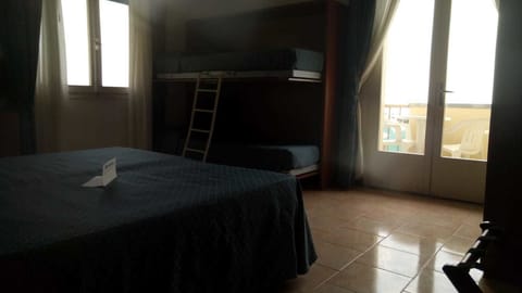 Quadruple Room, Balcony, Sea View | Minibar, in-room safe, desk, bed sheets