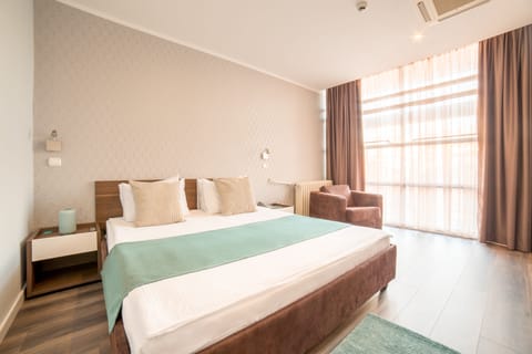 Basic Quadruple Room | Minibar, in-room safe, desk, blackout drapes