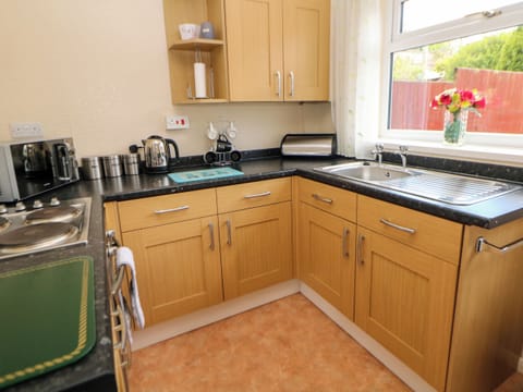 Cottage | Private kitchen | Fridge, microwave, stovetop, highchair