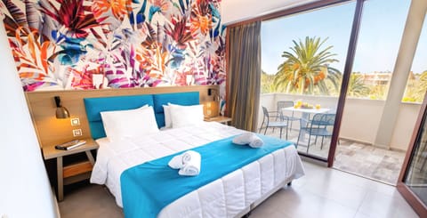 Family Quadruple Room, Garden View | Minibar, in-room safe, desk, iron/ironing board