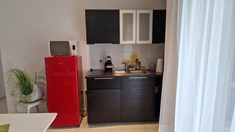 One-Bedroom Apartment with Pool View | Private kitchen | Coffee/tea maker, highchair, cleaning supplies, dining tables