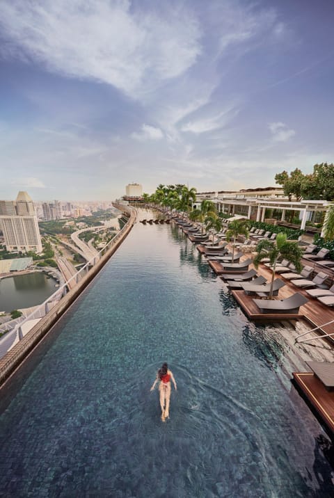 Outdoor pool, open 6:00 AM to midnight, pool umbrellas, sun loungers