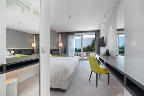 Double Room, Partial Sea View | Minibar, in-room safe, desk, laptop workspace