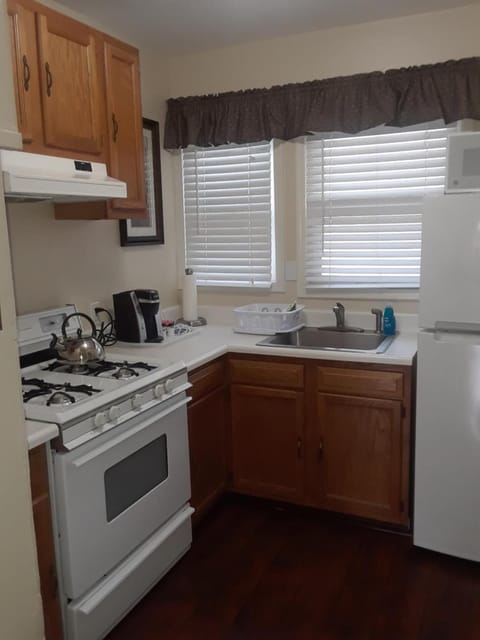 Fridge, microwave, coffee/tea maker, cookware/dishes/utensils