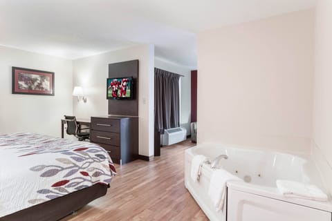 Suite, 1 King Bed, Non Smoking, Jetted Tub | Desk, laptop workspace, blackout drapes, iron/ironing board