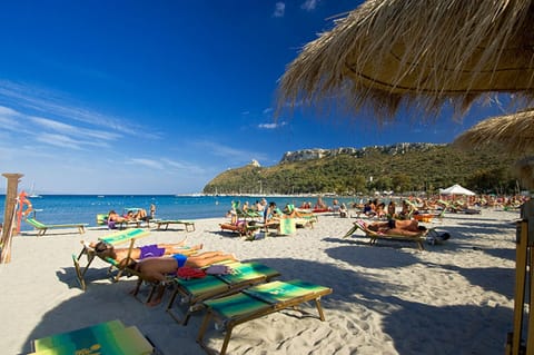 On the beach, white sand, sun loungers, beach umbrellas